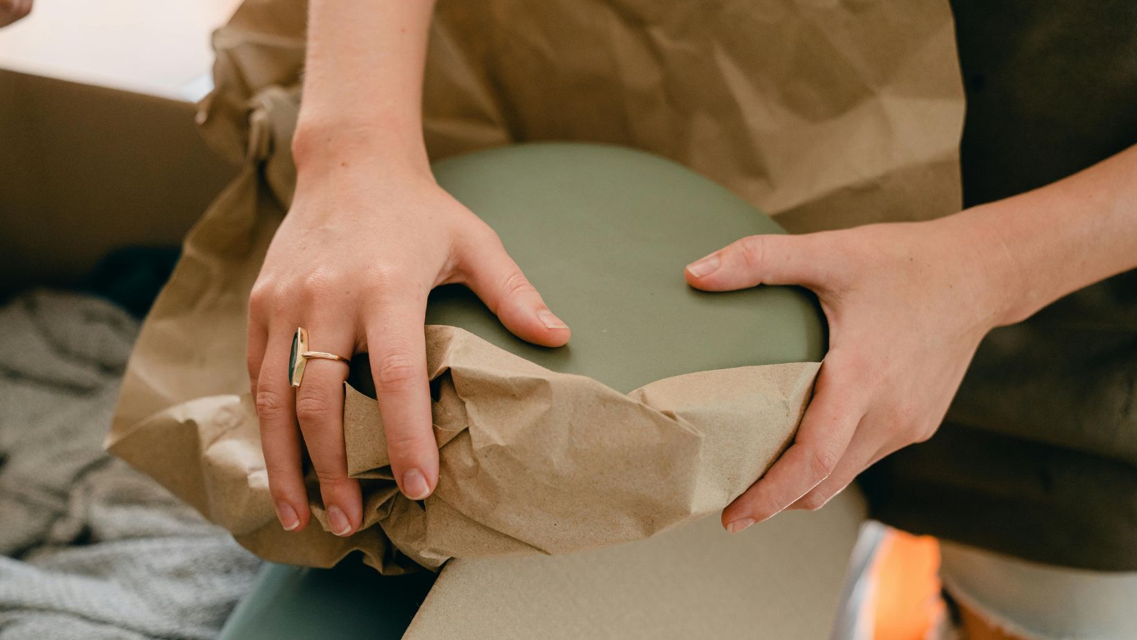 a close-up of two hands packing items for the move