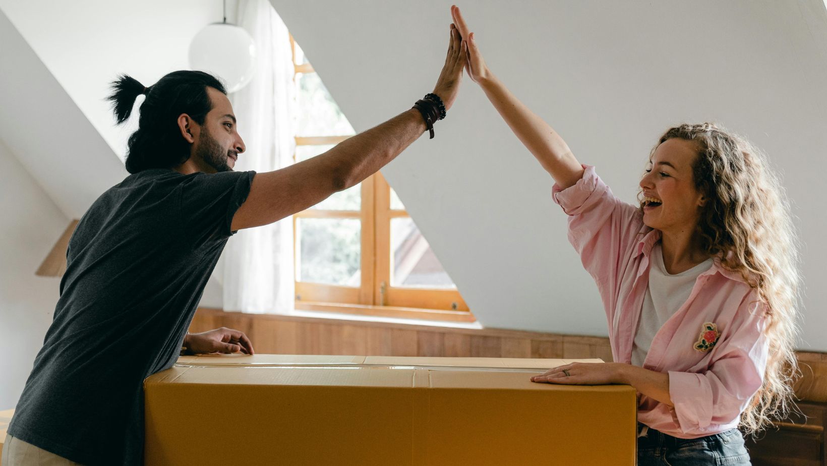 a man and a woman giving each other a high five